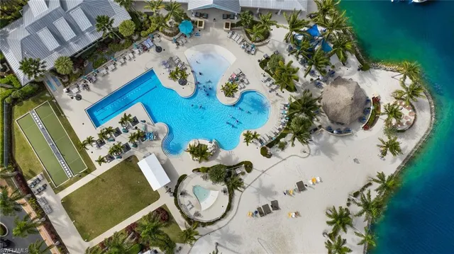 an aerial view of a house swimming pool and garden