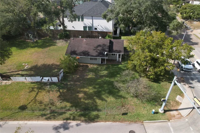 an aerial view of a house with a yard basket ball court and outdoor seating
