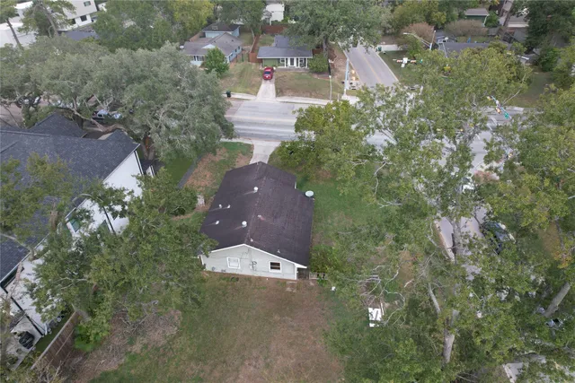 an aerial view of a house with yard