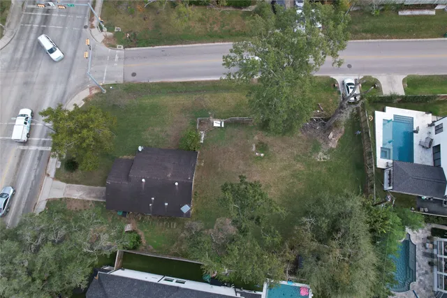an aerial view of a residential houses with outdoor space and street view