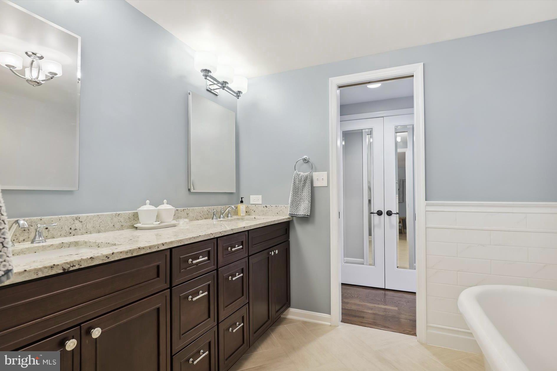 11310 Rolling House Road North Bethesda, MD 20852 - Photo 12 of 26 a bathroom with a granite countertop sink and a mirror