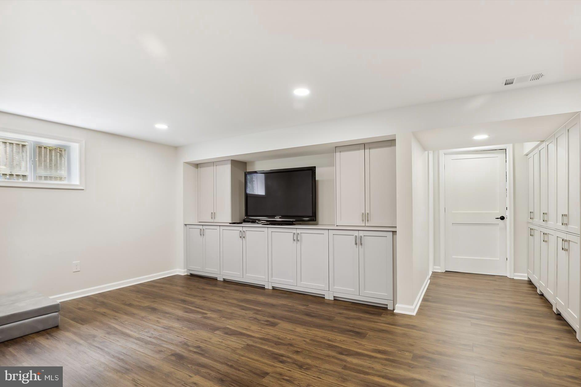 11310 Rolling House Road North Bethesda, MD 20852 - Photo 18 of 26 a view of a livingroom with wooden floor and a flat screen tv