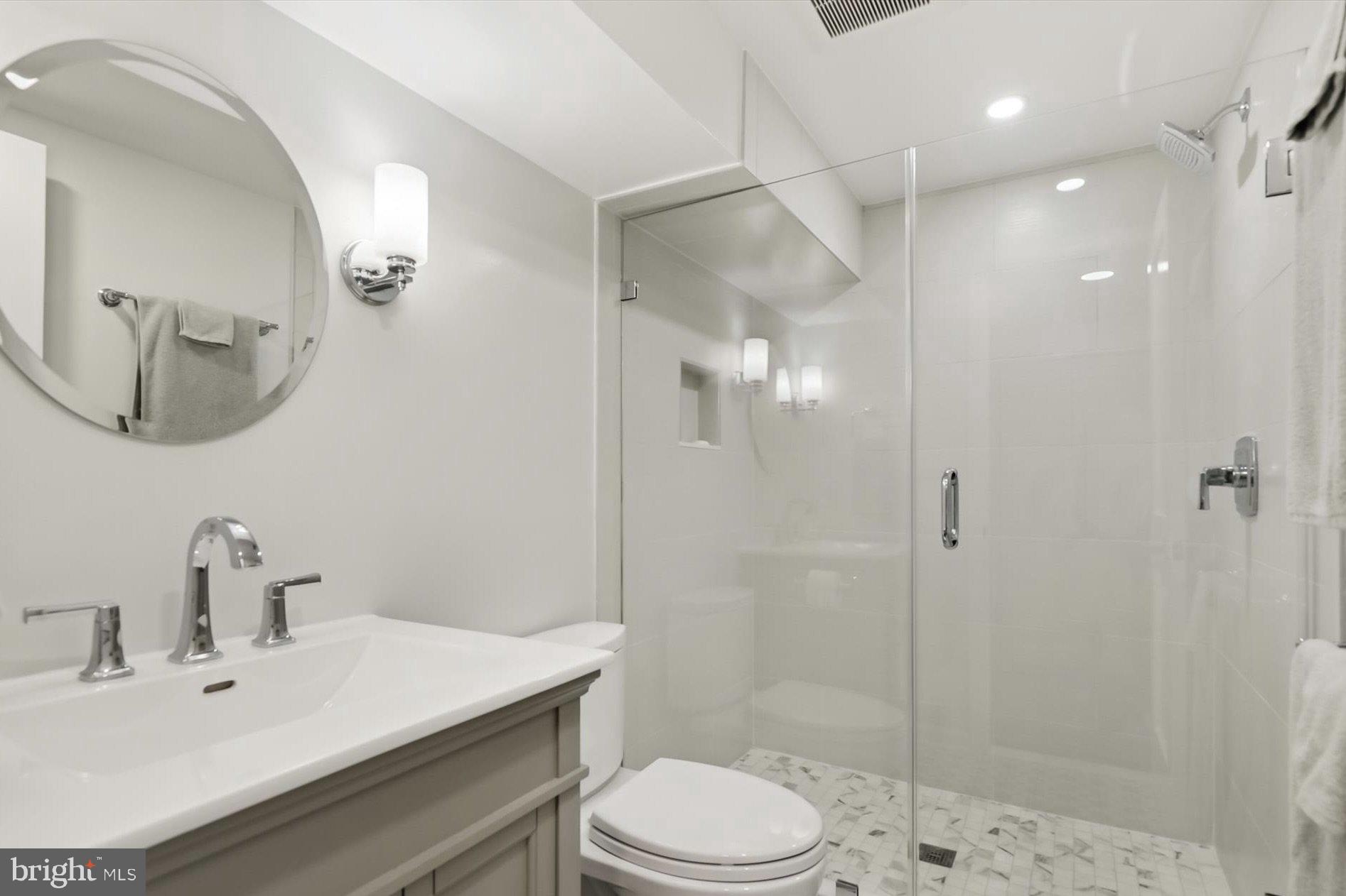 11310 Rolling House Road North Bethesda, MD 20852 - Photo 20 of 26 a bathroom with a sink toilet a mirror and shower