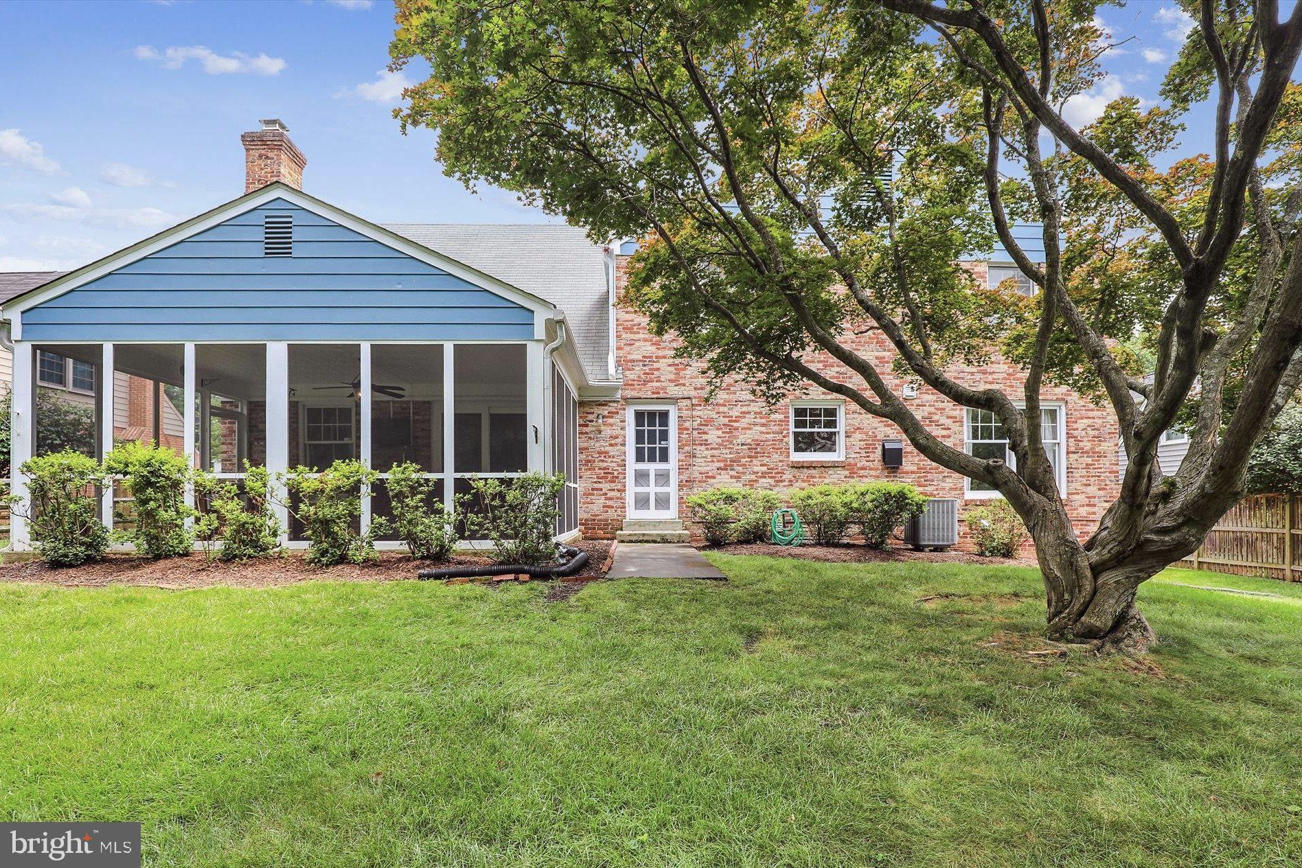 11310 Rolling House Road North Bethesda, MD 20852 - Photo 22 of 26 a front view of a house with a yard and trees