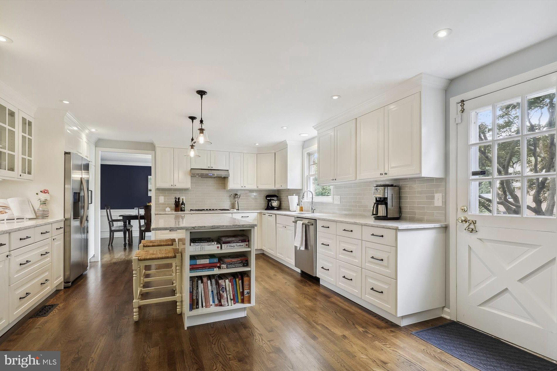 11310 Rolling House Road North Bethesda, MD 20852 - Photo 3 of 26 a large kitchen with white cabinets and wooden floor