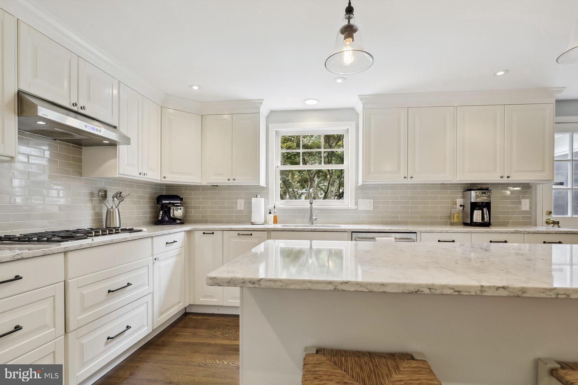 11310 Rolling House Road North Bethesda, MD 20852 - Photo 4 of 26 a kitchen with granite countertop white cabinets white appliances and sink