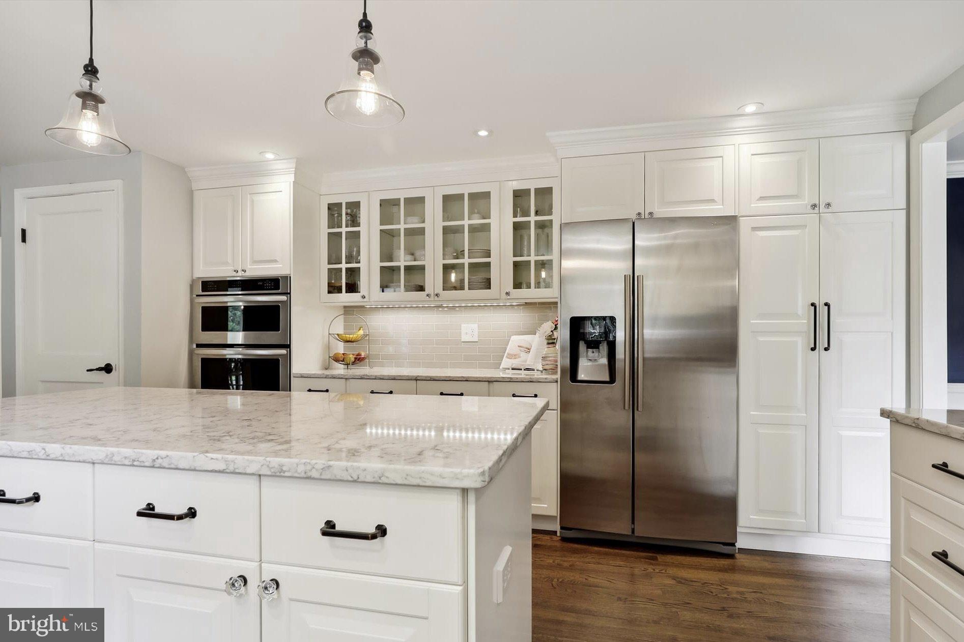 11310 Rolling House Road North Bethesda, MD 20852 - Photo 5 of 26 a kitchen with stainless steel appliances granite countertop a refrigerator and a stove top oven