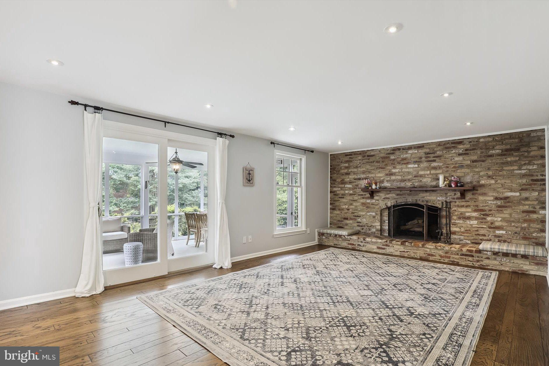 11310 Rolling House Road North Bethesda, MD 20852 - Photo 6 of 26 wooden floor fireplace and windows in an empty room