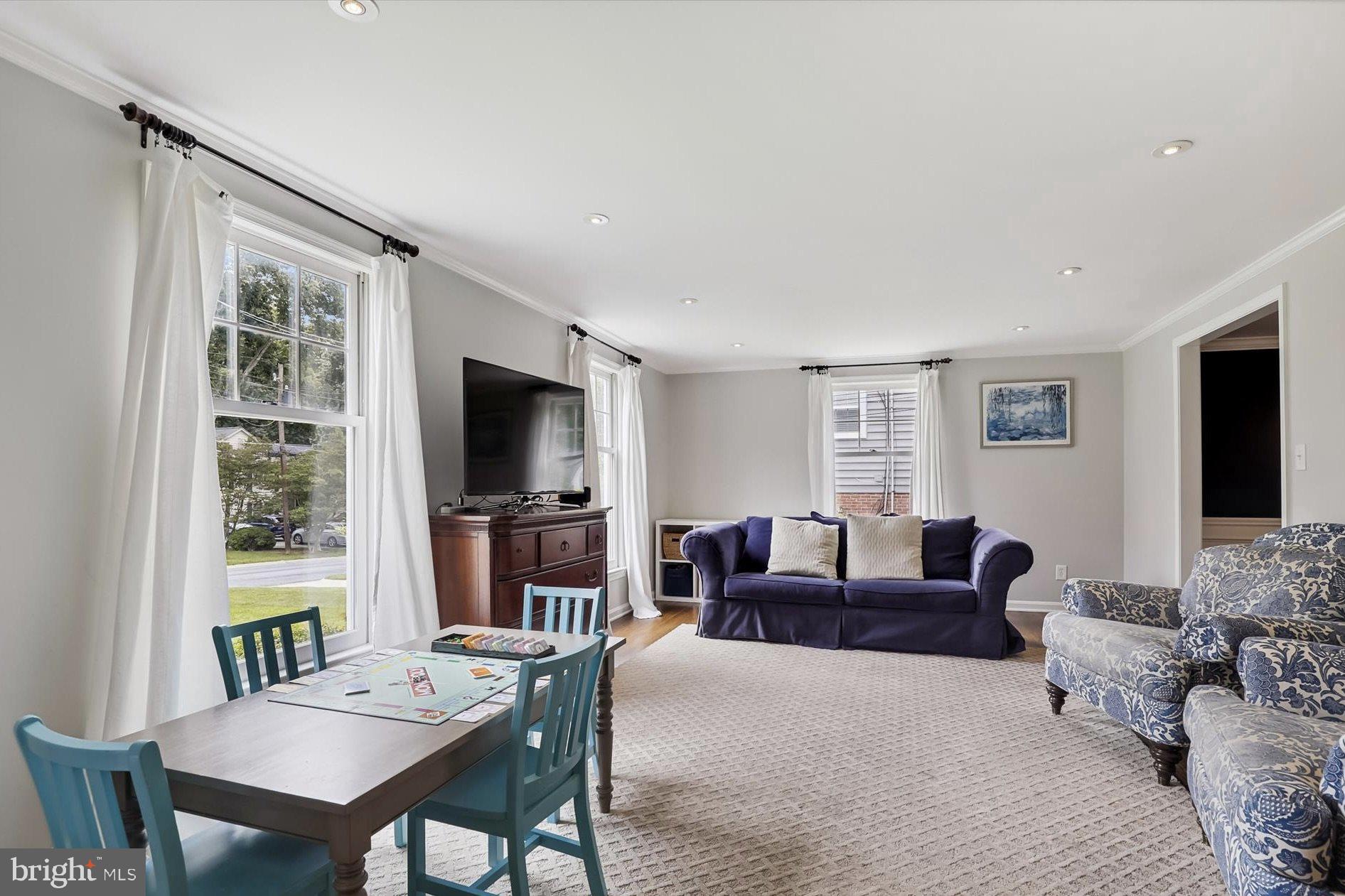 11310 Rolling House Road North Bethesda, MD 20852 - Photo 8 of 26 a living room with furniture a flat screen tv and a large window