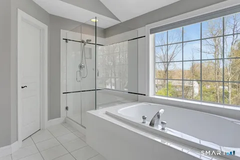 a bathroom with a bathtub and window