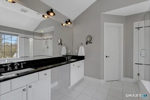 a large white kitchen with a sink and cabinets