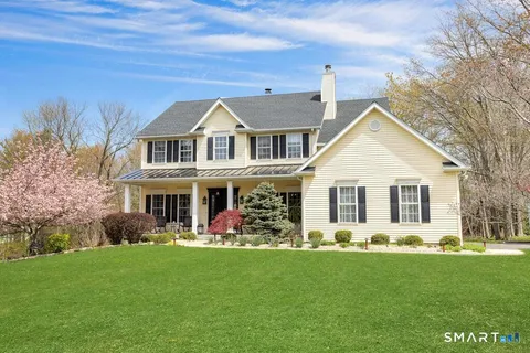 a front view of house with yard and green space