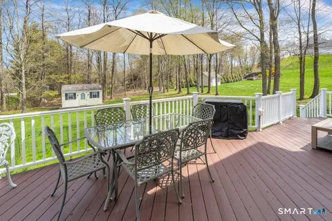 a view of a chair and table on the deck