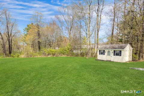 a front view of house with yard and trees
