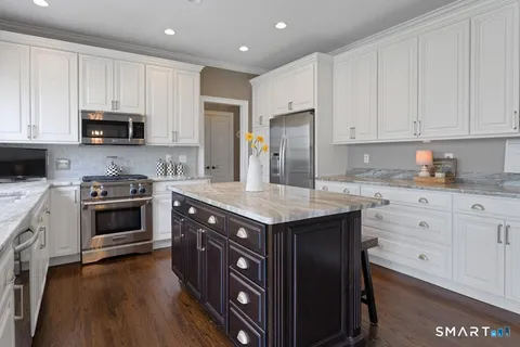 a kitchen with a sink stove and cabinets