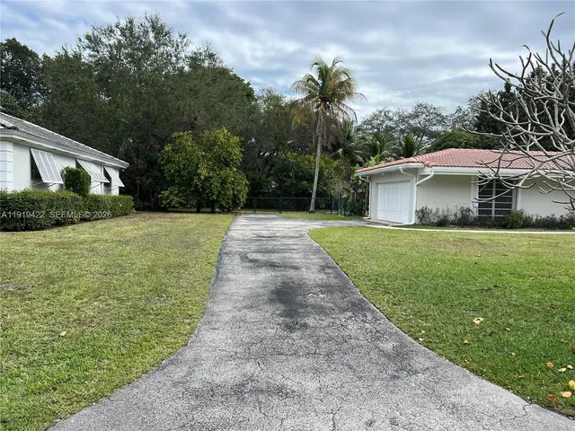 a front view of house with yard and trees