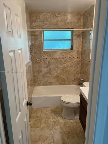 a bathroom with a toilet and a tub