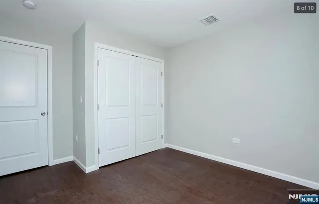 a bathroom with a toilet sink vanity and mirror