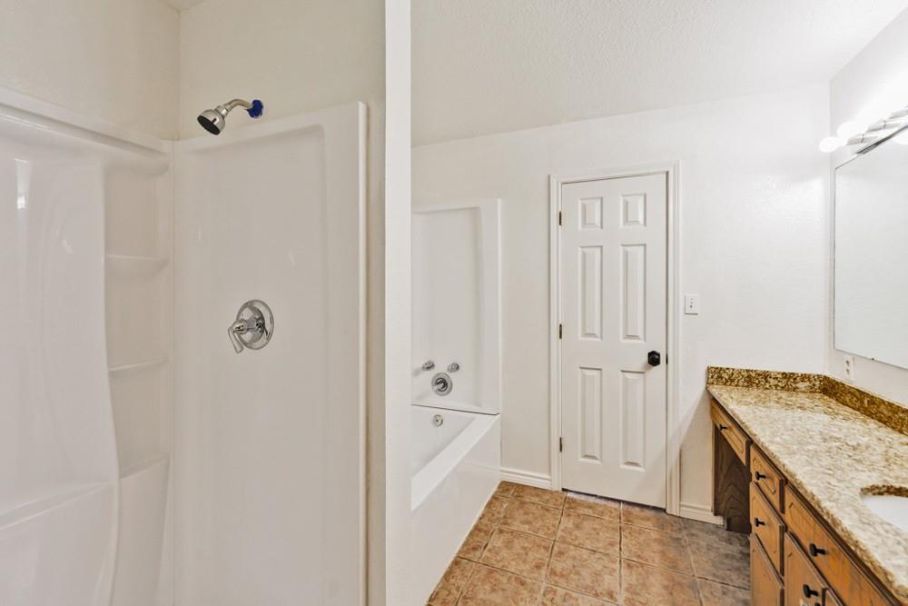 4316 Leona Road Bowie, TX 76230 - Photo 16 of 37 a bathroom with a granite countertop sink and a mirror