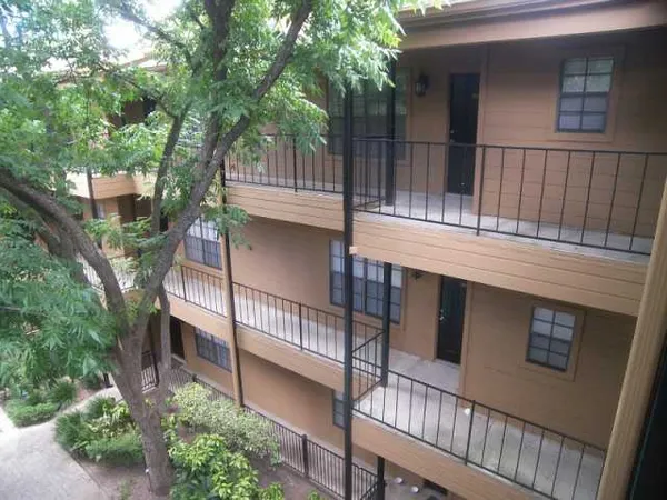 a view of a house with a tree beside it