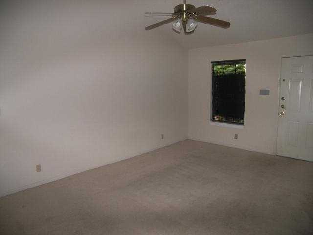 203 East 31st Street, Unit 310 Austin, TX 78705 - Photo 5 of 12 a view of a room with a ceiling fan and a window