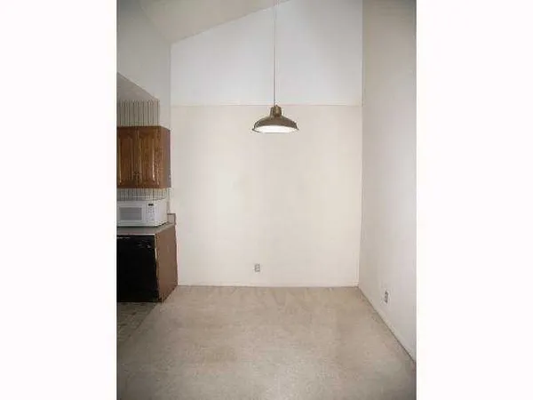 a view of a kitchen with a sink and a refrigerator