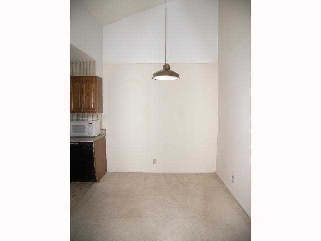 203 East 31st Street, Unit 310 Austin, TX 78705 - Photo 6 of 12 a view of a kitchen with a sink and a refrigerator