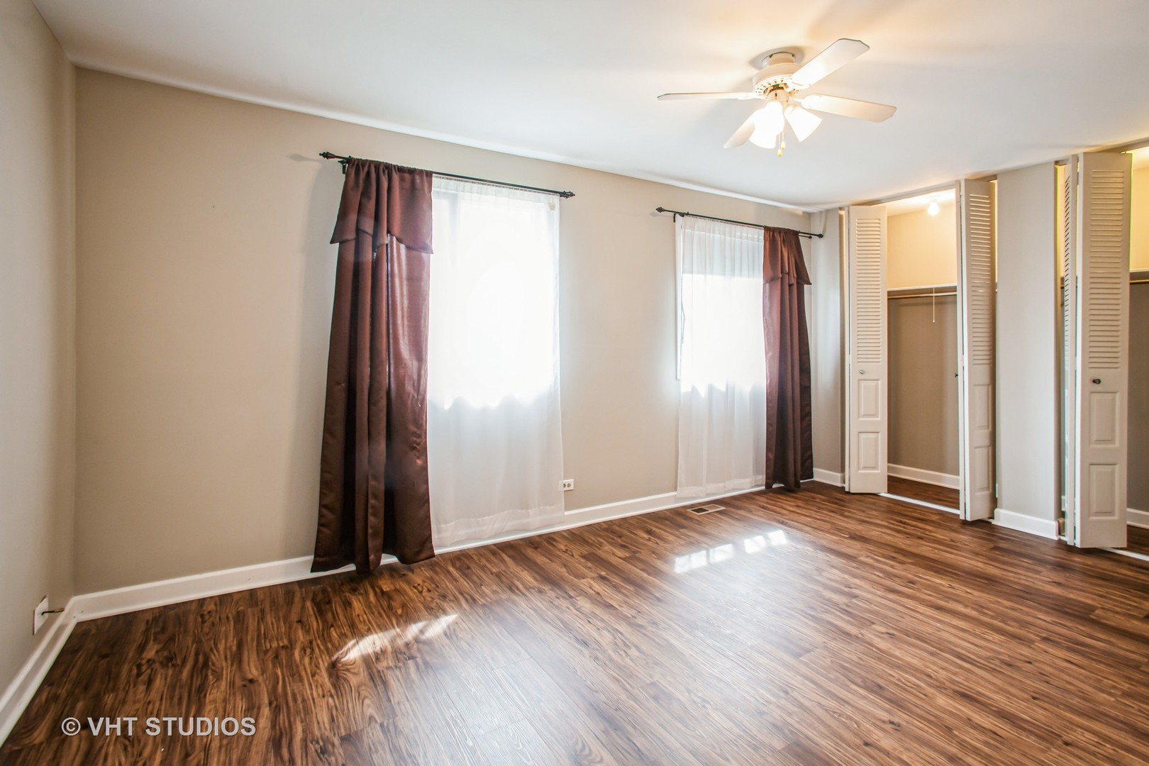 1660 Darwin Court Wheaton, IL 60189 - Photo 11 of 17 an empty room with wooden floor and windows