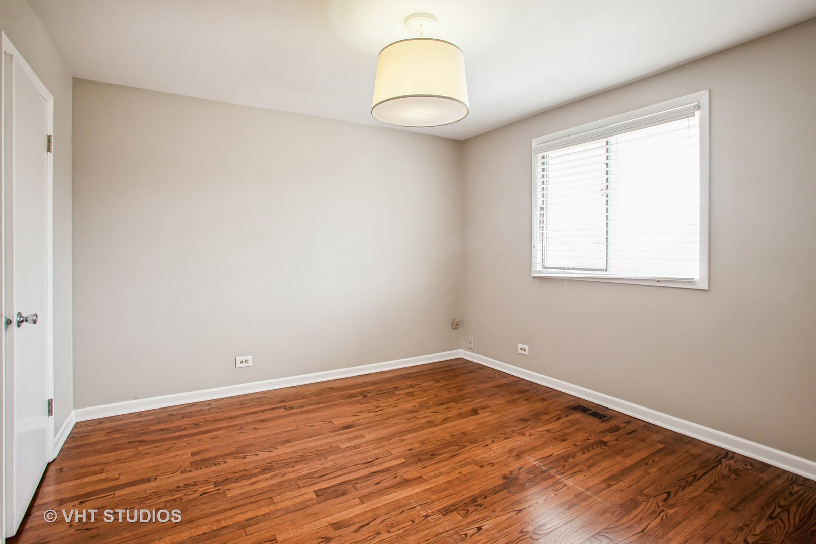 1660 Darwin Court Wheaton, IL 60189 - Photo 13 of 17 an empty room with wooden floor and windows