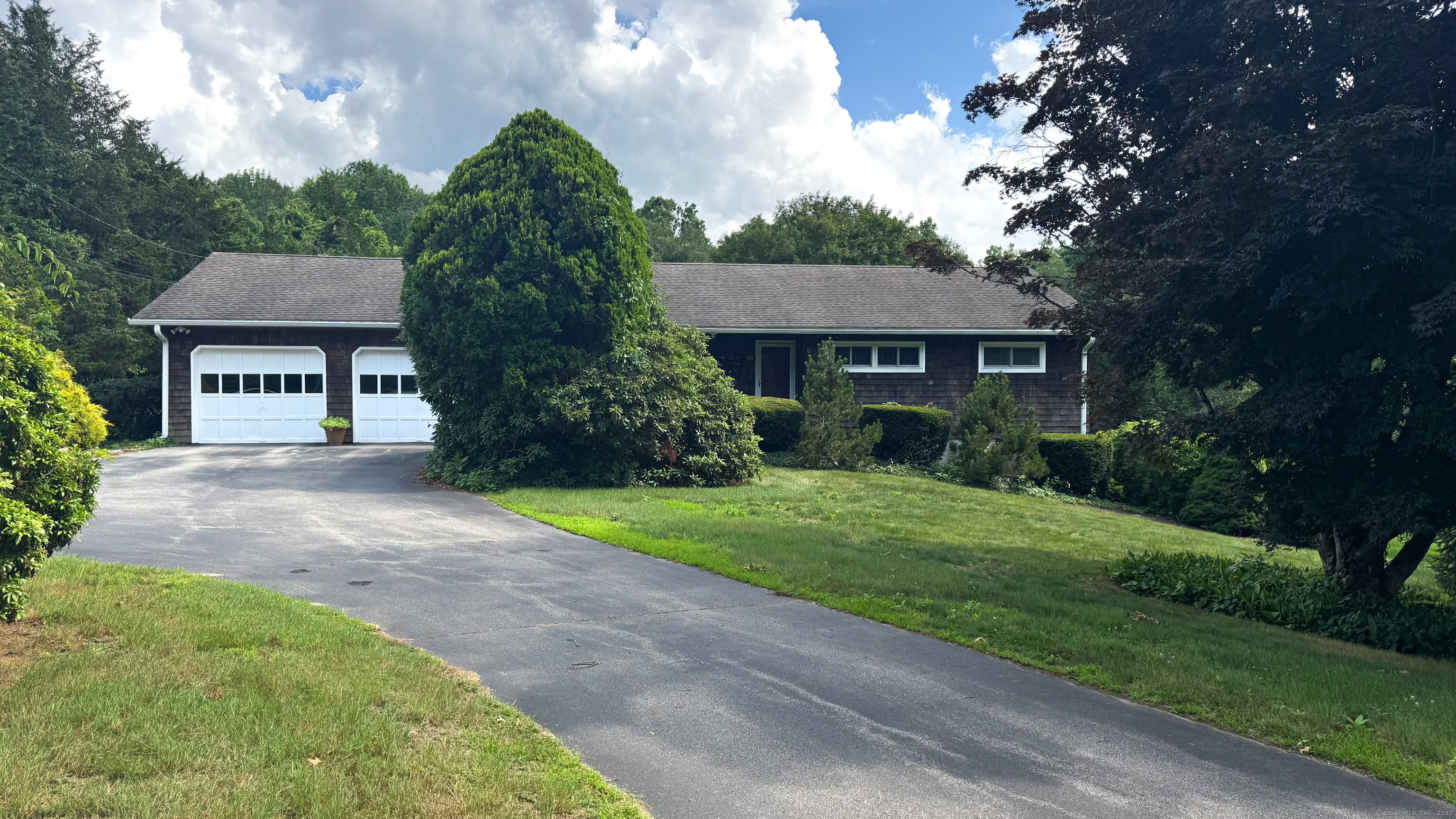 a front view of a house with garden
