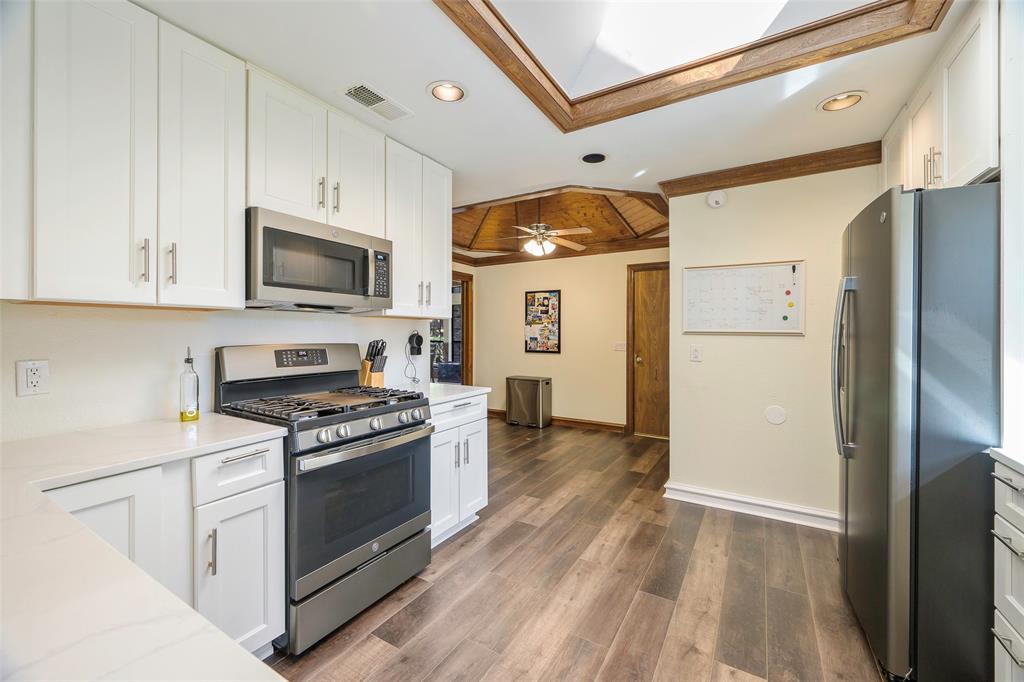 925 Spring Brook Drive Allen, TX 75002 - Photo 13 of 26 a kitchen with stainless steel appliances granite countertop a stove a refrigerator and a microwave