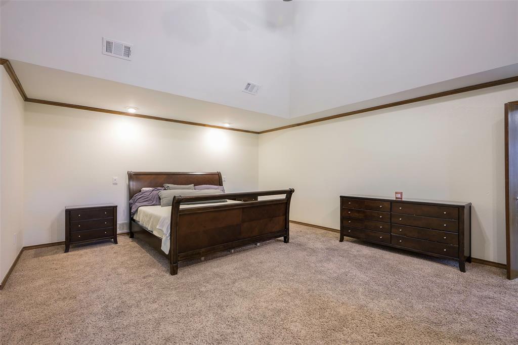 925 Spring Brook Drive Allen, TX 75002 - Photo 17 of 26 a bedroom with furniture and cabinets