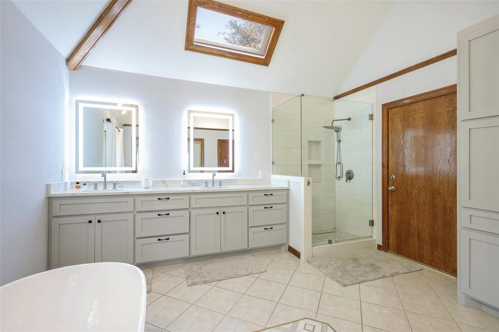 925 Spring Brook Drive Allen, TX 75002 - Photo 19 of 26 a spacious bathroom with a shower sink and mirror