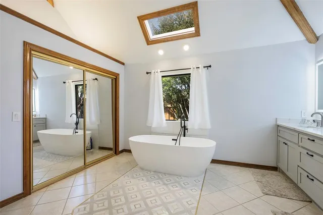 a spacious bathroom with a bathtub and sink