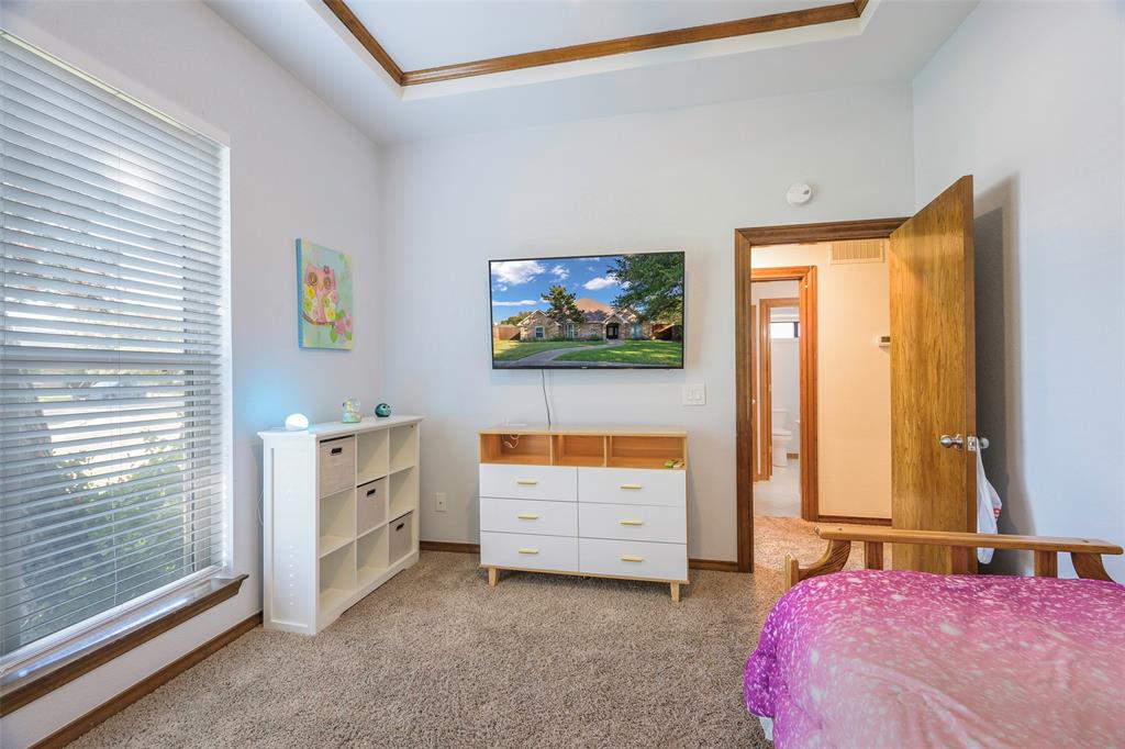 925 Spring Brook Drive Allen, TX 75002 - Photo 22 of 26 a bedroom with bed and window