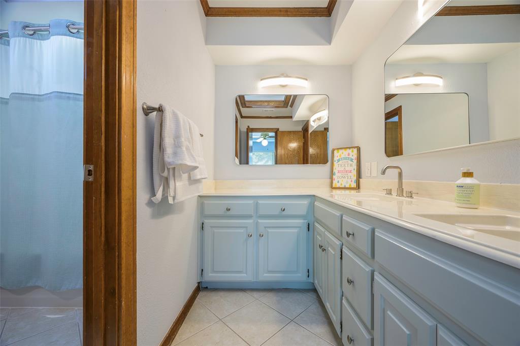 925 Spring Brook Drive Allen, TX 75002 - Photo 23 of 26 a spacious bathroom with a granite countertop sink and a mirror
