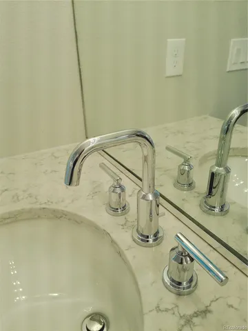 a bathroom with a granite countertop sink