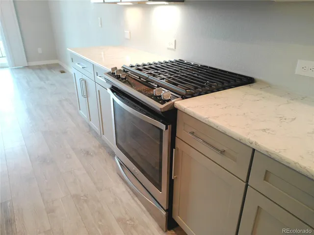 a stove top oven sitting inside of a kitchen