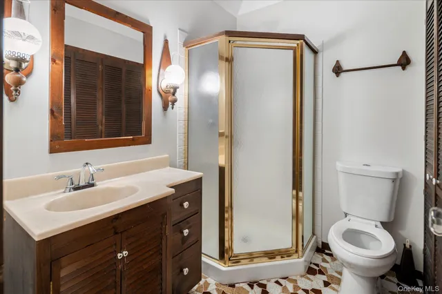 a bathroom with a sink toilet and shower