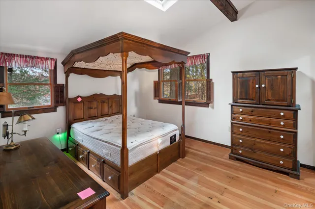 a bedroom with a bed and a dresser