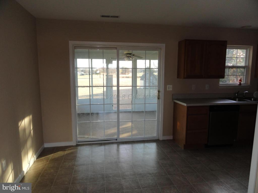 36245 Richland Road Willards, MD 21874 - Photo 3 of 14 a view of empty room with wooden floor and fan