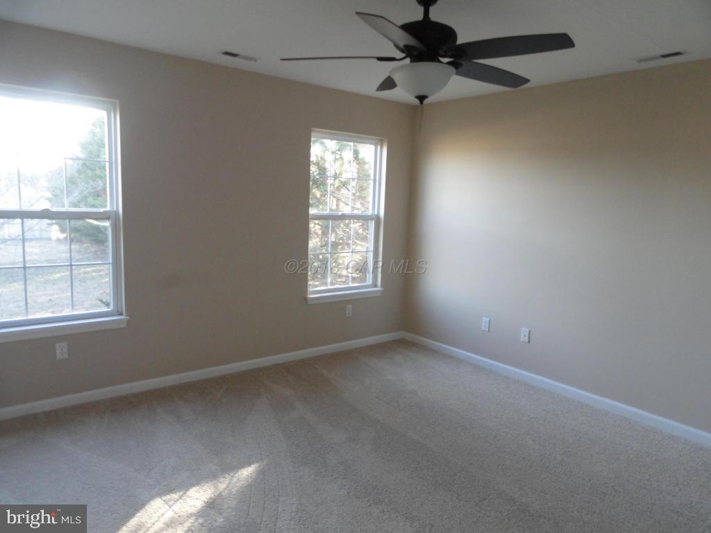 36245 Richland Road Willards, MD 21874 - Photo 9 of 14 an empty room with a window and a fan