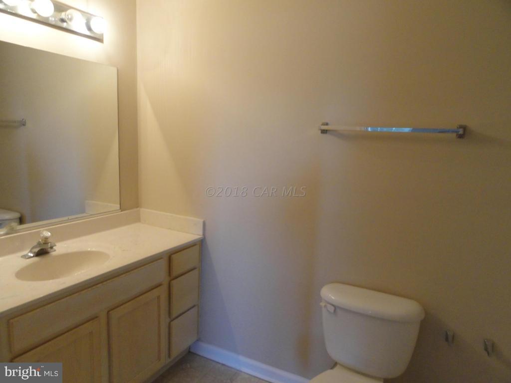 36245 Richland Road Willards, MD 21874 - Photo 10 of 14 a bathroom with a toilet sink and vanity