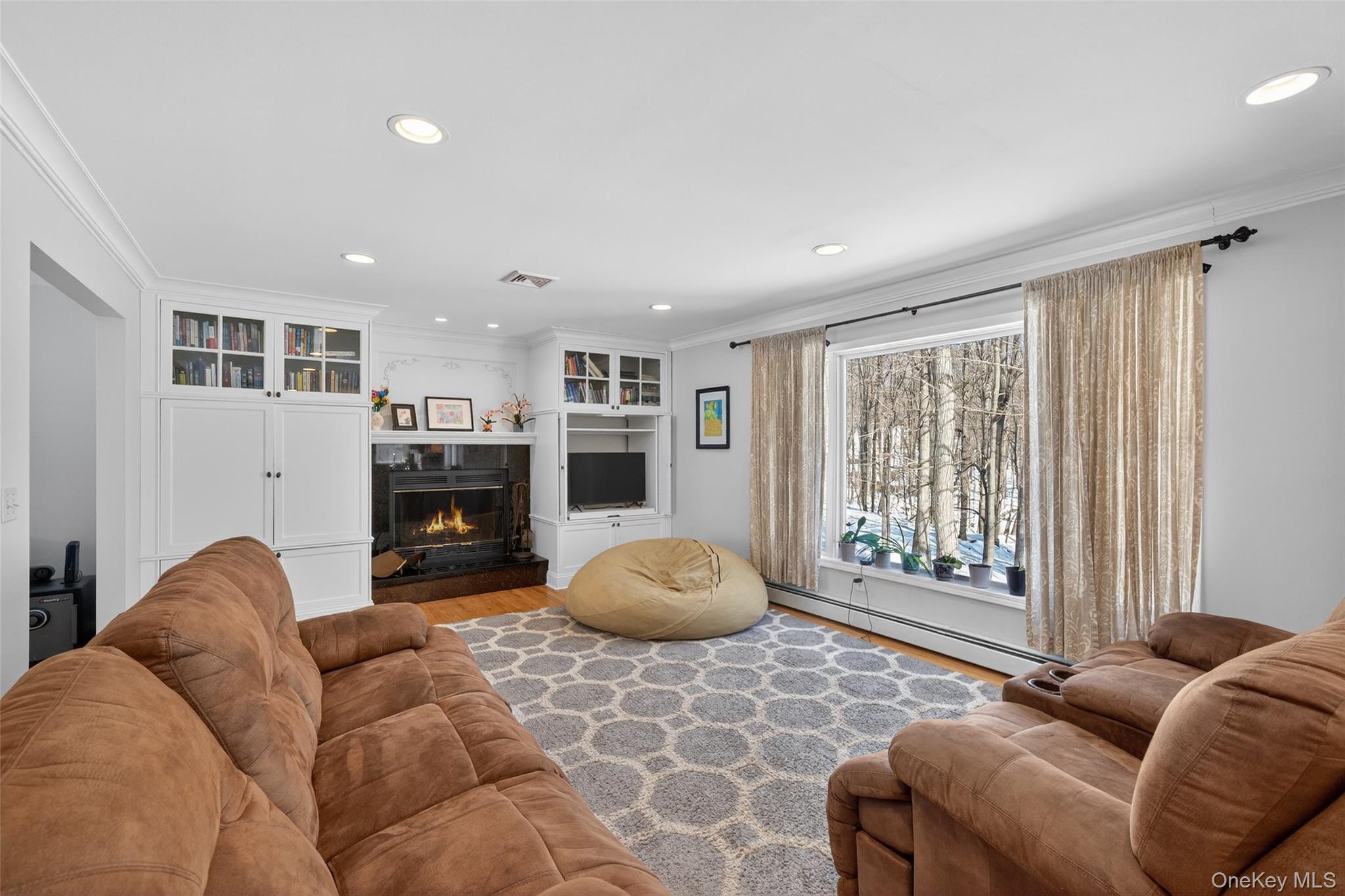 34 Booth Road Chester, NY 10918 - Photo 13 of 42 Living area with crown molding, built in cabinetry, fireplace, recessed lighting, and wood finished floors