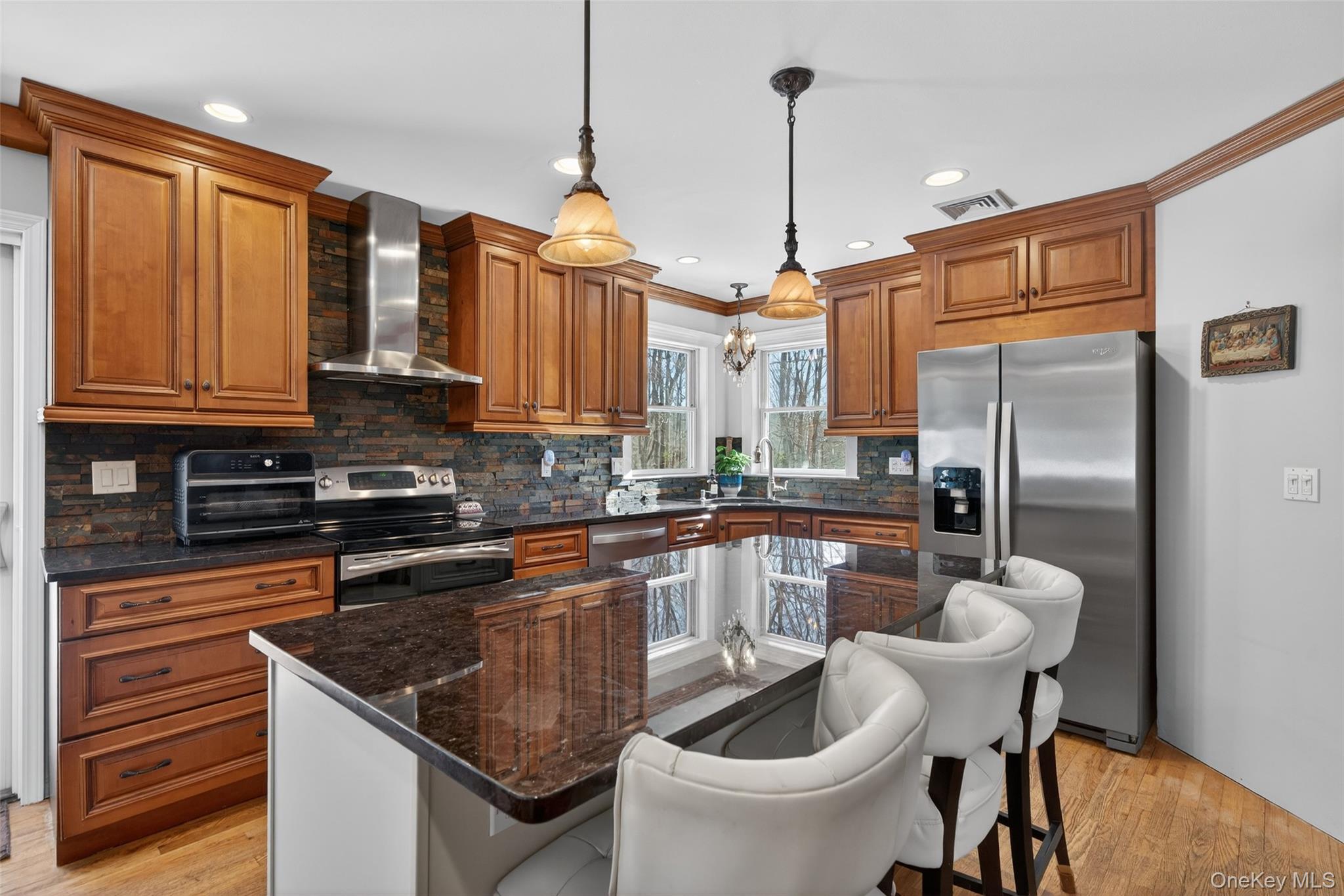 34 Booth Road Chester, NY 10918 - Photo 10 of 42 Kitchen with an island, wood finish cabinetry, stainless steel appliances, and granite counters