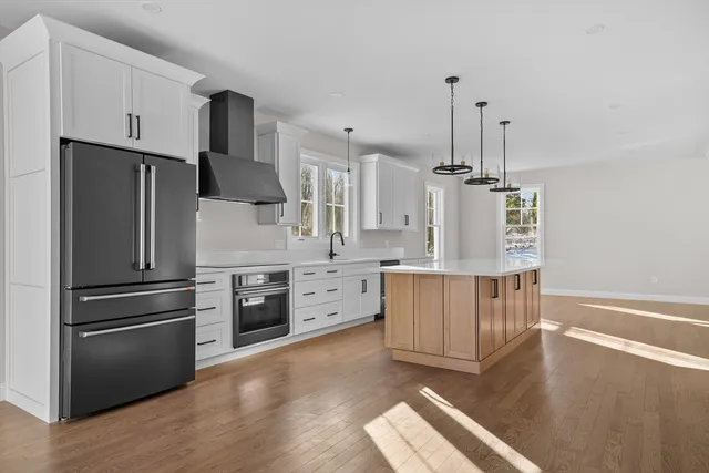 a kitchen with stainless steel appliances sink refrigerator and microwave