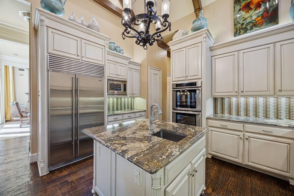 6640 Briar Ridge Lane Plano, TX 75024 - Photo 15 of 40 Beamed cathedral ceiling, upper and lower cabinet lighting, abundance of cabinets, microwave and large walk in pantry