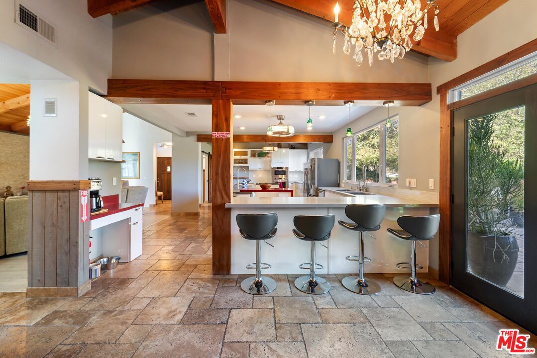 39700 Ave Arizona Temecula, CA 92591 - Photo 3 of 23 a kitchen with stainless steel appliances kitchen island granite countertop a table and chairs in it