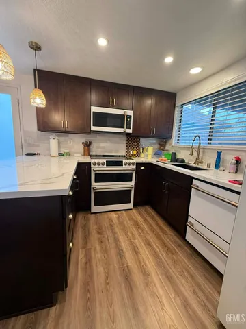 a kitchen with a sink a stove and cabinets