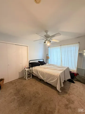 a bed room with a bed and a window